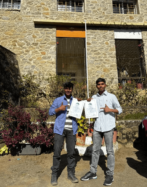Wall-climbing participants displaying achievement certificates